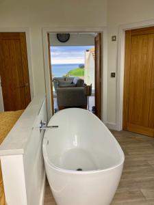a bathroom with a white sink in a room at Kittiwake Retreat, a luxury escape by the sea! in Gorran Haven +31 photos