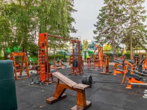 a playground with a wooden bench in a park at Novotel Gdańsk Marina in Gdańsk