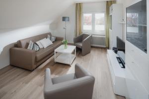 TV a/nebo společenská místnost v ubytování Haus Coordes Wohnung 04
