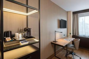 Uma TV ou centro de entretenimento em NH Geneva Airport Hotel