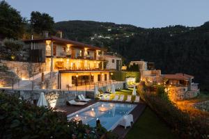 a house with a swimming pool in front of a building at Dajas Douro Valley - Exclusive Villas in Casais