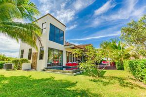 a house with a palm tree in front of it at Wild Orchid in Placencia