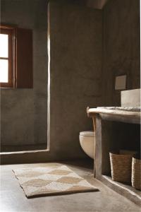 a bathroom with a tub and a toilet and a sink at Muxima - Aljezur in Aljezur
