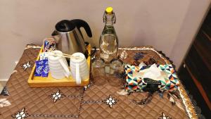 a table with a table cloth with a bottle of wine at Lill Sparrow by Verdant escapes hospitality in Dharamshala +38 photos