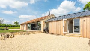a barn conversion with sliding glass doors and a building at Pipehouse in Bath