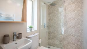 a bathroom with a shower and a toilet and a sink at Pipehouse in Bath +14 photos