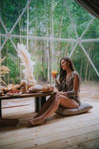 a woman sitting on a table in a tent at Glamp Podróżnika i Marzyciela in Rogówko +24 photos