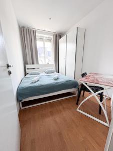 a small bedroom with a bed and a table at Gorgeous Central Apartment in Bratislava with Free Private Parking in Staré Mesto