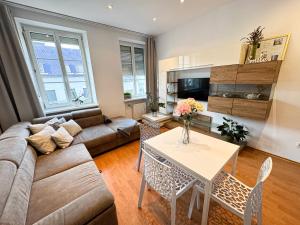 a living room with a couch and a table at Gorgeous Central Apartment in Bratislava with Free Private Parking in Staré Mesto