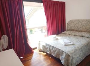 Postel nebo postele na pokoji v ubytování Residence Villa Viola fronte lago