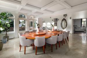 a dining room with a large wooden table and chairs at Uhu Villa 750 m2 - Budapest in Budapest