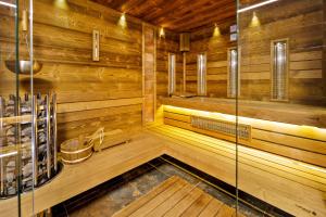 a sauna with wooden walls and wooden flooring at Uhu Villa 750 m2 - Budapest in Budapest
