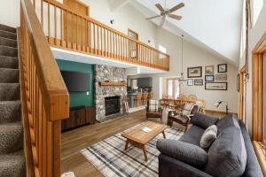 a living room with a couch and a fireplace at Up North Chalet Ac Bbq Bikes in Cedar