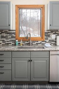 a kitchen with a sink and a window at Up North Chalet Ac Bbq Bikes in Cedar