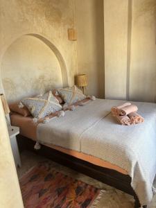 a bedroom with a large bed with pillows at Riad Dar Dayana in Essaouira