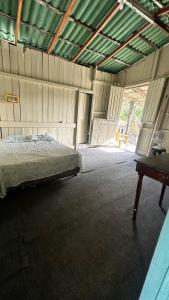 an empty barn with a bed in a room at HOSTEL MAIANDEUA in Algodoal