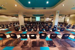 a large room with chairs and a stage in it at Hotel Kraljevi Čardaci in Kopaonik +69 photos