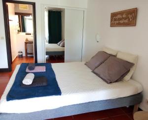a bedroom with a bed with a blue towel on it at Le Chacha Anse des Rochers in Saint-François +9 photos