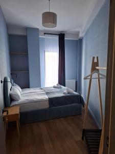 a blue bedroom with a bed and a window at New Gudauri Two Bedroom Apartment Neo Building in Gudauri