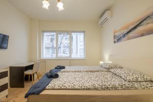 a bedroom with a bed with a teddy bear on it at Stylish TOP center Flat 100m to Vitosha blvd in Sofia