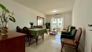 a dining room with a green table and chairs at Altura Beach Apartment in Altura
