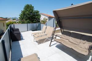 een patio met ligstoelen op een dak bij Villa Canolle Istria in Vodnjan