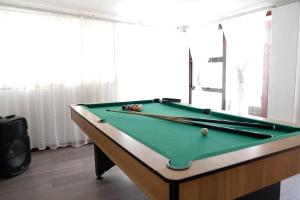 a pool table with two cuesticks on top of it at Villa on Flamingo Vlei in Cape Town