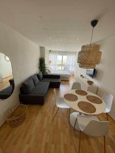 a living room with a couch and a table and chairs at Top Costa del Sol in Torremolinos