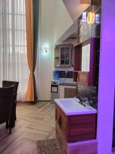 a kitchen with a sink and a counter with purple lighting at Exquisite 6 bedroom Villa in Nakuru in Nakuru