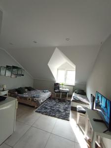 a attic room with two beds and a desk at Niyaz apartment in Warsaw