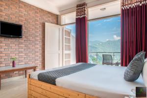 a bedroom with a bed and a large window at Exotic Stays I 2Bhk Kasauli Home l Mountains & Toy Train View in Kasauli