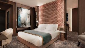 Tempat tidur dalam kamar di Nobel Design Hotel