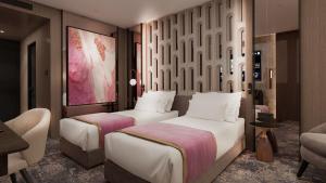 Tempat tidur dalam kamar di Nobel Design Hotel