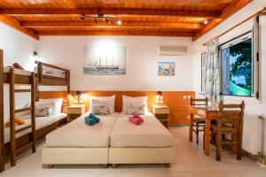a bedroom with two bunk beds and a desk at Kontaratos Studios & Apartments in Parikia