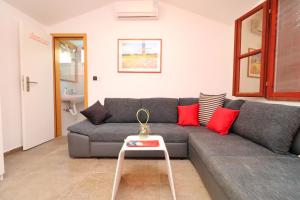 a living room with a couch and a table at Holiday Home Marco's Place in Vela Luka +23 photos