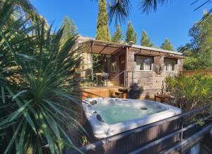 a hot tub in front of a house at Les Jardins de l'Oustal in Narbonne