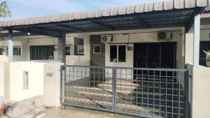 a house with a gate and a fence at Ed 01 sitiawan homestay in Sitiawan