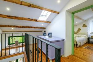 a room with a bed and a staircase with a window at Rural Home Oriana in Manjadvorci +22 photos