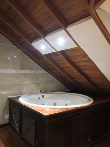 a large bath tub in a room with an attic at La Posada Encantada in Mar del Plata
