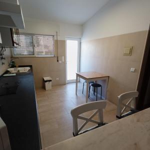a kitchen with a table and chairs in a room at Lagos Charming Villas in Lagos