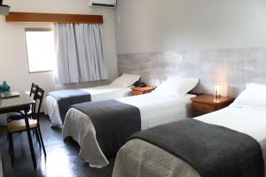 Posteľ alebo postele v izbe v ubytovaní ARQ Inn Hotel