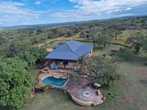 an overhead view of a large building with a swimming pool at Mkhiweni 3 Bedroom Villa at Dombeya Wildlife Estate in Mbabane