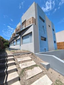 a building with stairs in front of it at Duplex Espigón Oeste in Monte Hermoso