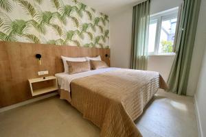 a bedroom with a large bed in a room at Villas Punta Silo - luxury apartments with pool in Šilo +172 photos