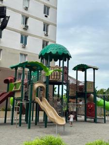 a playground with a slide in front of a building at Saekyung village 1 in Agus