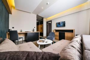 a living room with a couch and a table at Hotel Kraljevi Čardaci in Kopaonik