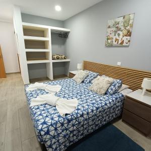 a bedroom with a bed with towels on it at Lagos Charming Villas in Lagos +26 photos