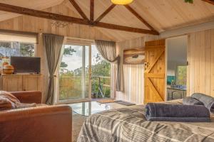a bedroom with a bed and a large window at Urchins Nest in Woolacombe