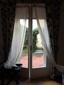 an open door with white curtains in a room at Angolo Verde in Santa Margherita Ligure