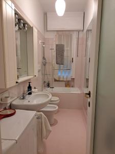 a white bathroom with a sink and a toilet at Angolo Verde in Santa Margherita Ligure
